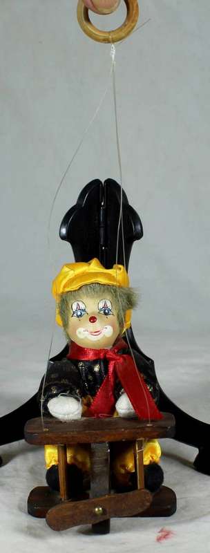CLOWN SITTING IN A PLANE HANGING FROM A ROPE  - BID NOW!!