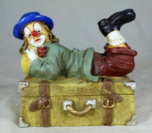 Clown laying on a treasure chest