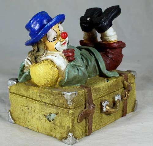 Clown laying on a treasure chest