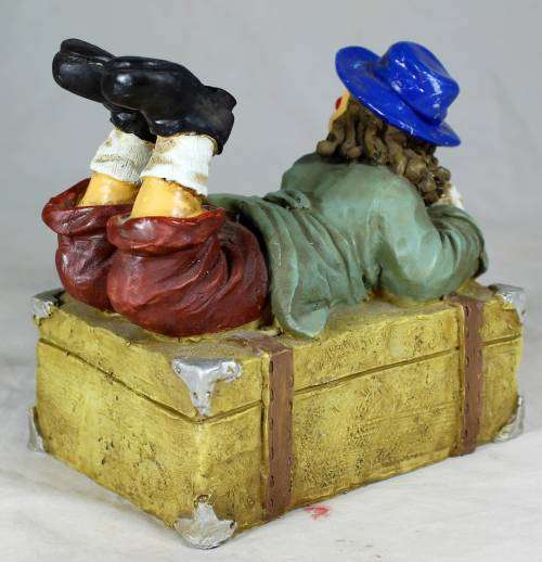 Clown laying on a treasure chest