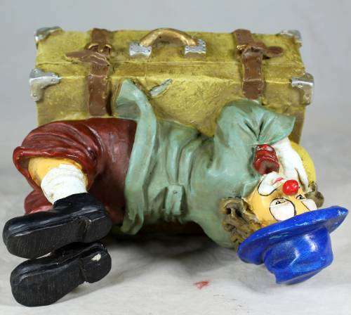 Clown laying on a treasure chest