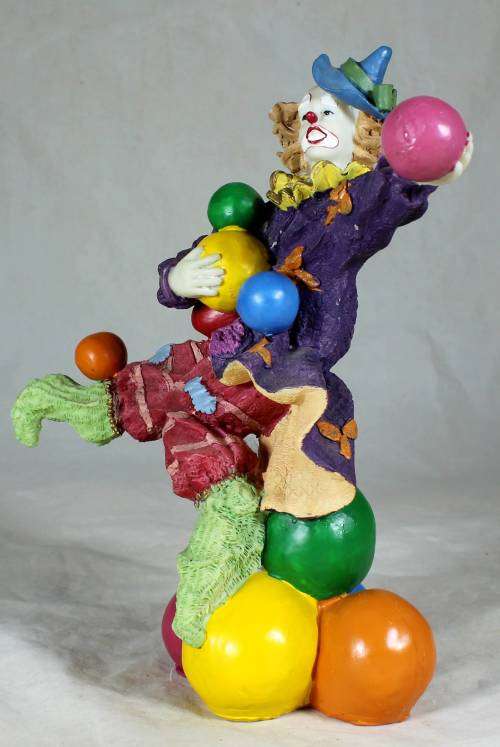 CLOWN STANDING ON BALLS WHILE JUGGLING BALLS - BID NOW!!