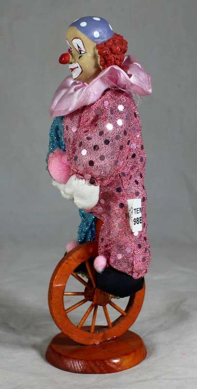 CLOWN SITTING ON A UNICYCLE - BID NOW!!