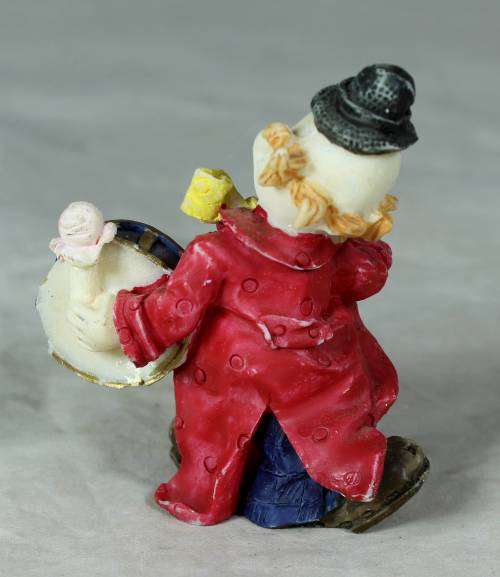 Molded clown playing a drum