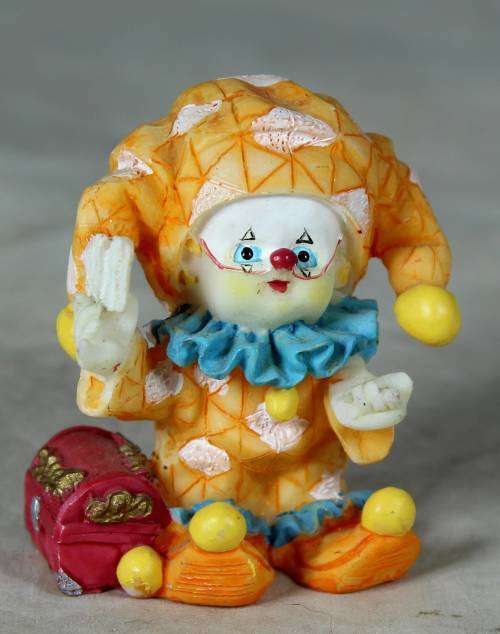 Molded orange clown with a treasure chest