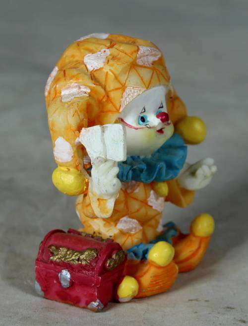 Molded orange clown with a treasure chest