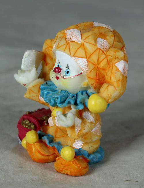 Molded orange clown with a treasure chest