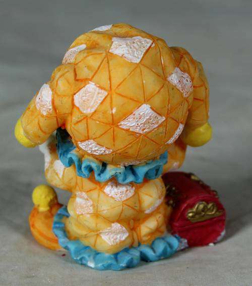 Molded orange clown with a treasure chest