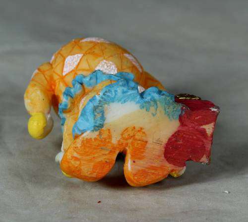 Molded orange clown with a treasure chest