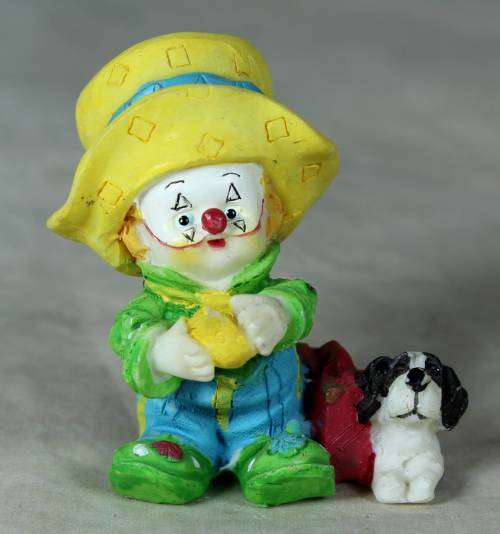 MOLDED CLOWN IN A LARGE YELLOW HAT WITH HIS DOG