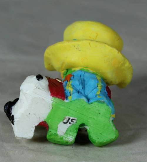 MOLDED CLOWN IN A LARGE YELLOW HAT WITH HIS DOG