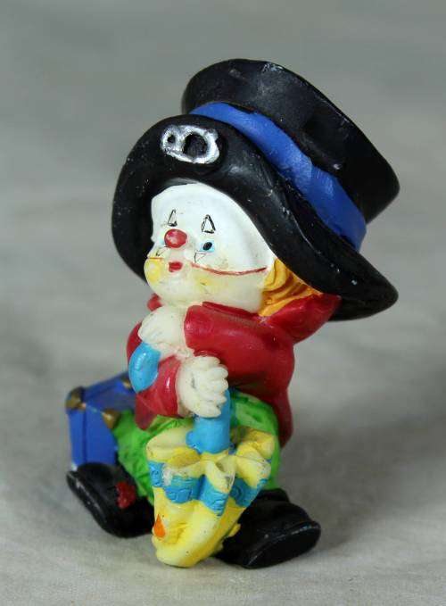 MOLDED CLOWN IN A  BLACK HAT & UMBRELLA WITH A SUITCASE