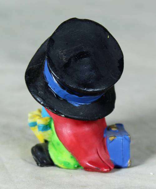MOLDED CLOWN IN A  BLACK HAT & UMBRELLA WITH A SUITCASE