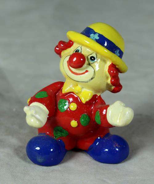 Molded clown in a yellow hat with red hair