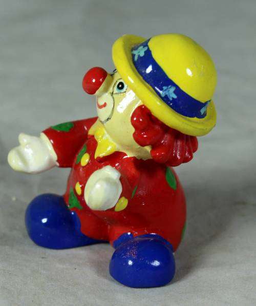 Molded clown in a yellow hat with red hair