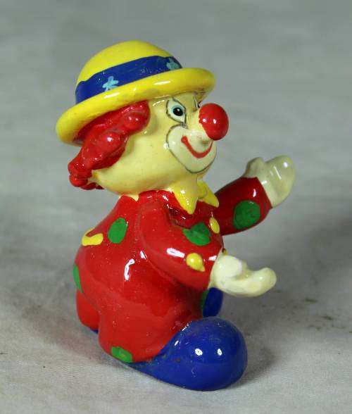 Molded clown in a yellow hat with red hair
