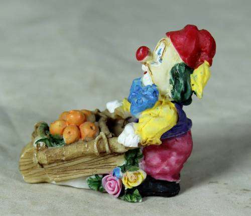 Molded clown pushing a fruit basket