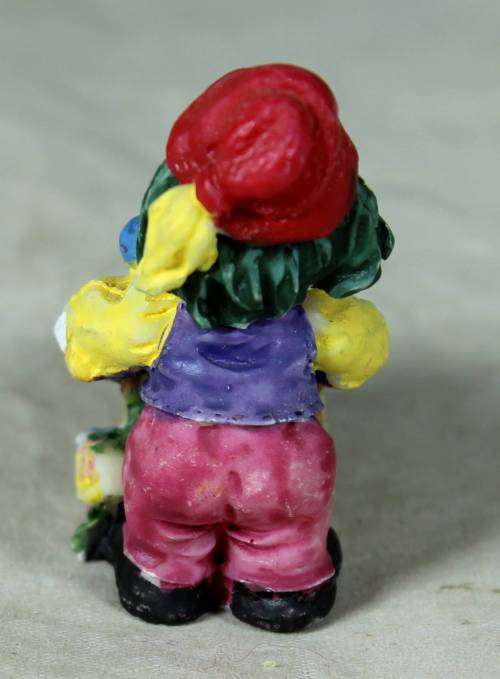 Molded clown pushing a fruit basket