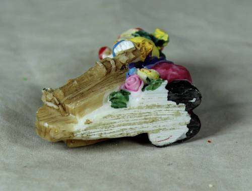 Molded clown pushing a fruit basket