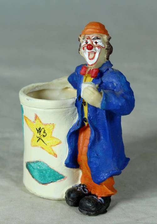 Molded clown holding a toothpick holder