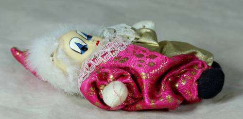 PORCERLAIN AND CLOTH  PIERRIOT IN A GOLD AND PINK SUIT