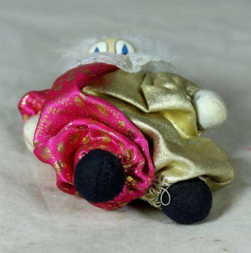 PORCERLAIN AND CLOTH  PIERRIOT IN A GOLD AND PINK SUIT