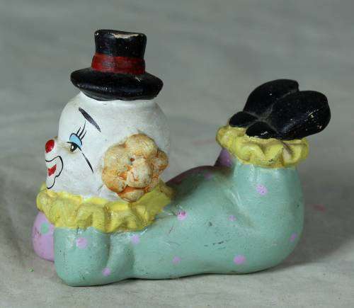 Ceramic clown laying down