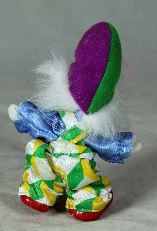 porcelain and cloth clown with a purple bowtie