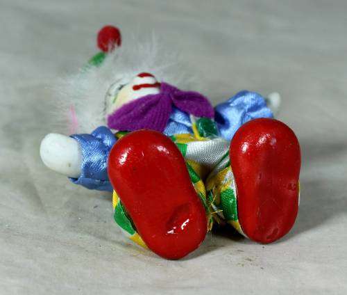 porcelain and cloth clown with a purple bowtie