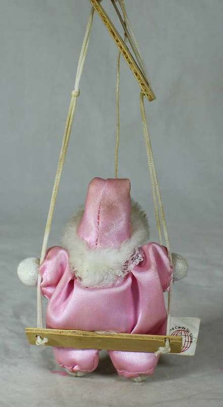 PORCERLAIN AND CLOTH CLOWN DRESSED IN PINK ON A ROPE