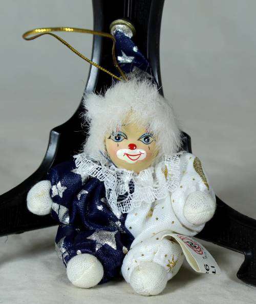porcelain and cloth clown dressed in a blue&white moon&stars outfit