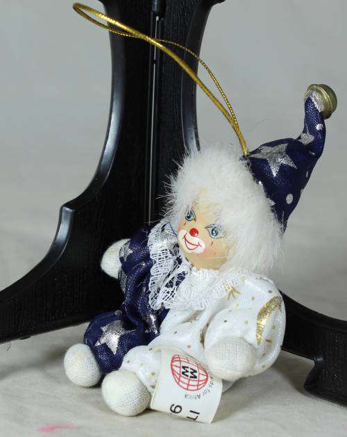 porcelain and cloth clown dressed in a blue&white moon&stars outfit