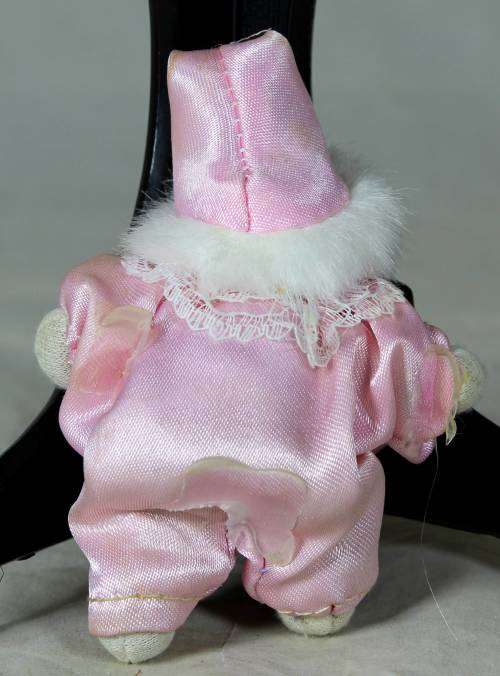 porcelain and cloth clown dressed in a pink jump suit