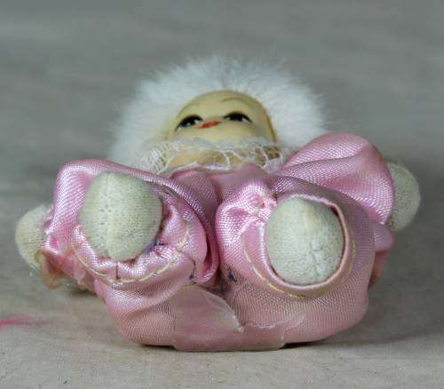 porcelain and cloth clown dressed in a pink jump suit