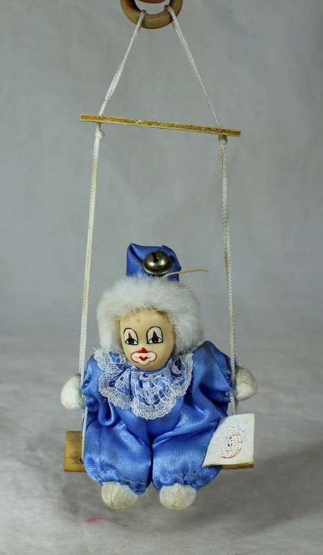 porcelain and cloth clown dressed in blue on a rope