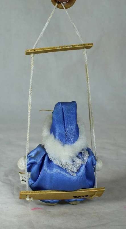 porcelain and cloth clown dressed in blue on a rope