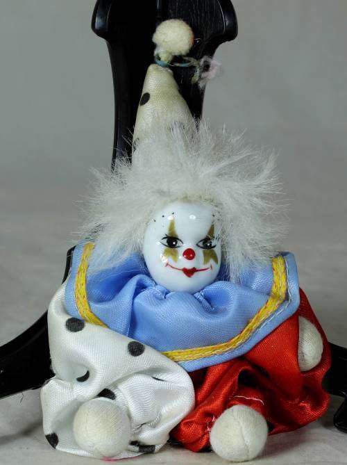 porcelain and cloth clown with white hair