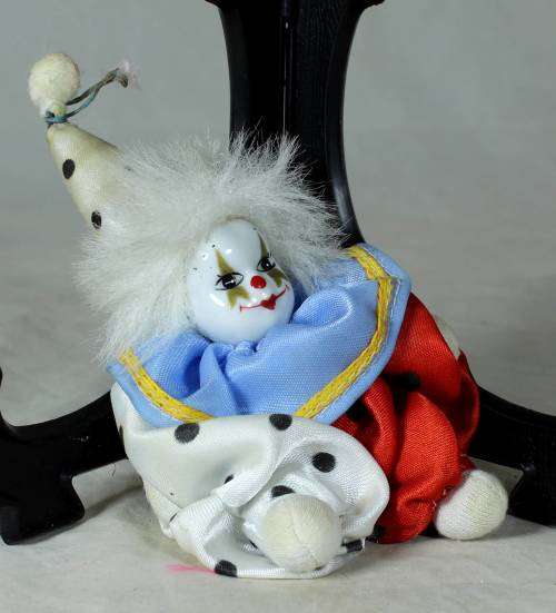 porcelain and cloth clown with white hair