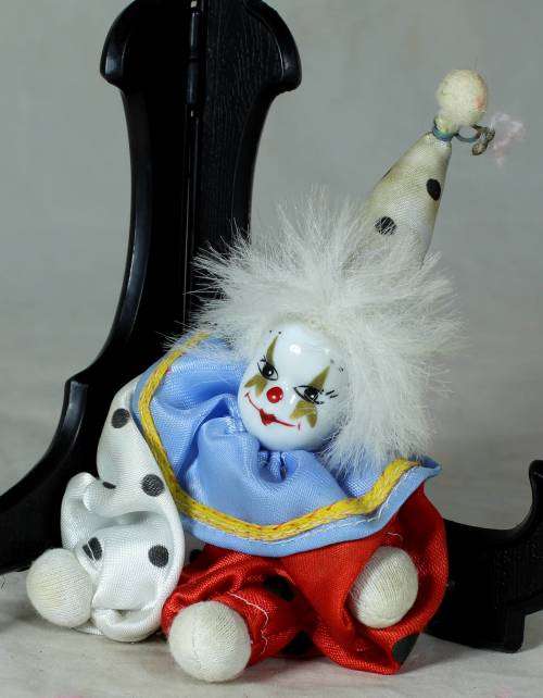 porcelain and cloth clown with white hair