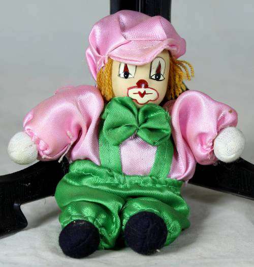 porcelain and cloth clown dressed in green and pink