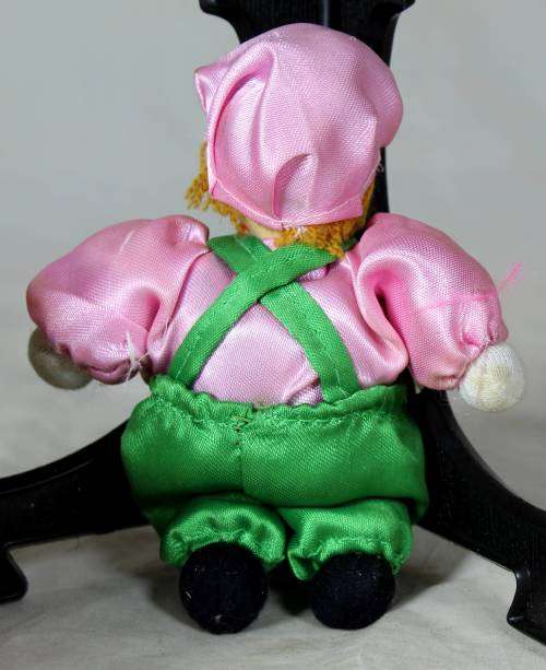 porcelain and cloth clown dressed in green and pink