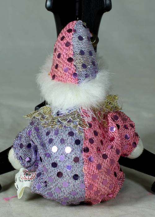 porcelain and cloth clown dressed in a glitter jump suit