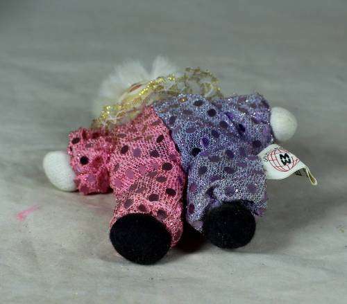 porcelain and cloth clown dressed in a glitter jump suit