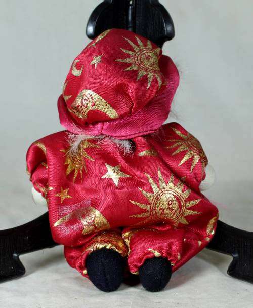 porcelain and cloth clown dressed in a red jump suit