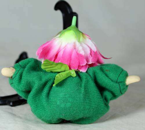 porcelain and cloth clown dressed in a green jump suit