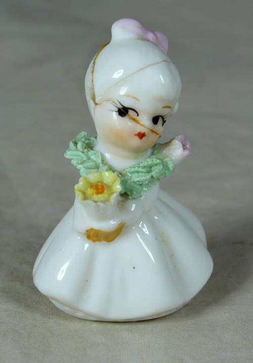 CERAMIC LITTLE GIRL HOLDING A BOUQUET OF FLOWERS