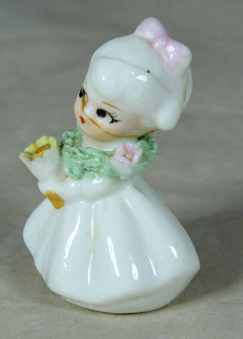 CERAMIC LITTLE GIRL HOLDING A BOUQUET OF FLOWERS