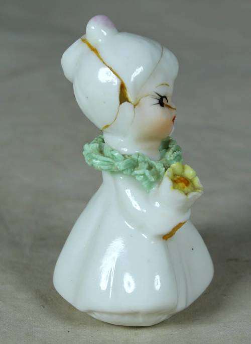 CERAMIC LITTLE GIRL HOLDING A BOUQUET OF FLOWERS