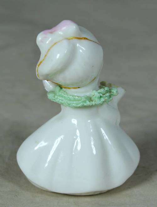 CERAMIC LITTLE GIRL HOLDING A BOUQUET OF FLOWERS