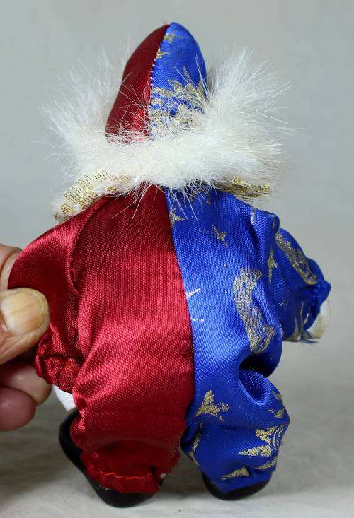 Porcelain and cloth clown dressed in a blue and purple jump suit